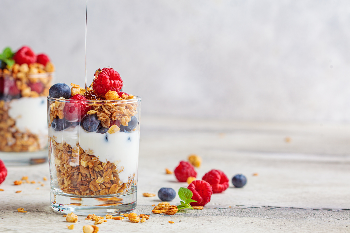 Yogurt Parfait with Granola and Berries in Glasses