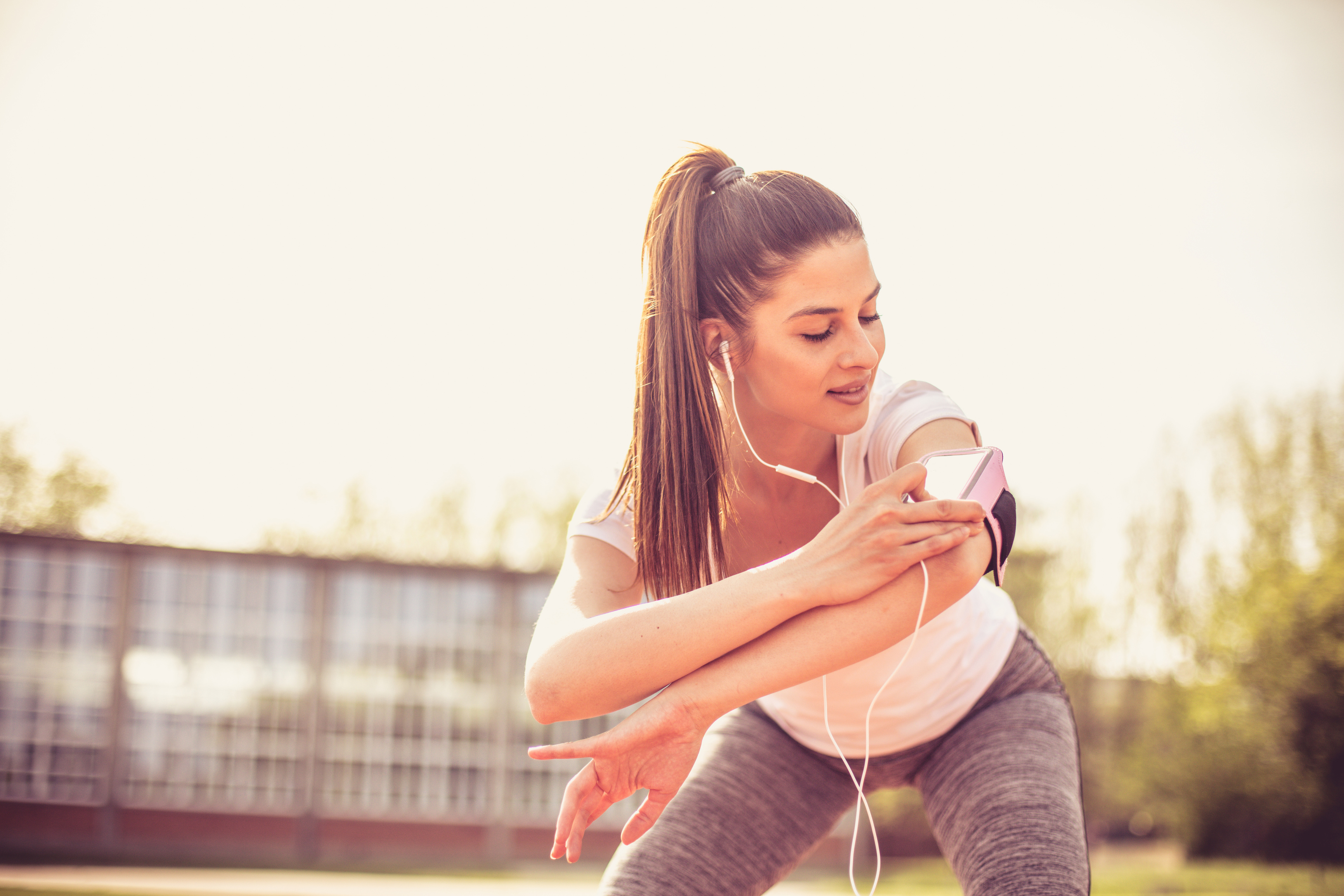 Smiling young woman exercise outside.